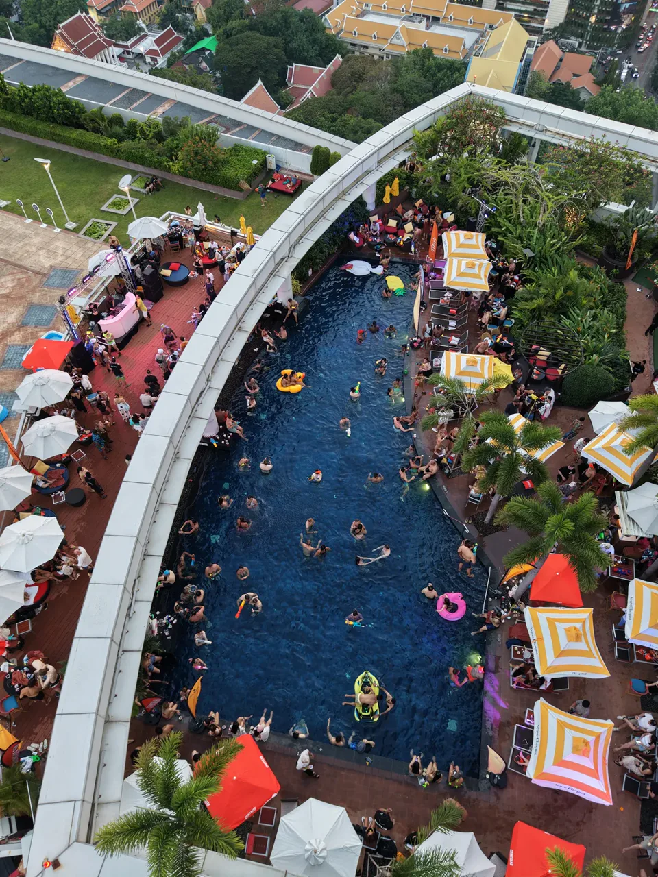 An aerial photo of guests in the Centara rooftop pool and on the deck during the day
