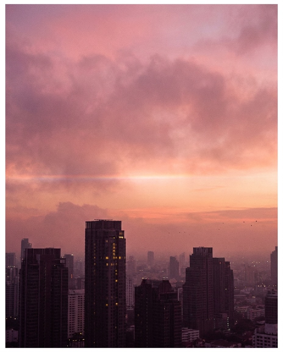 The original DHT artwork: pink and lavender dusk over the Bangkok skyline
